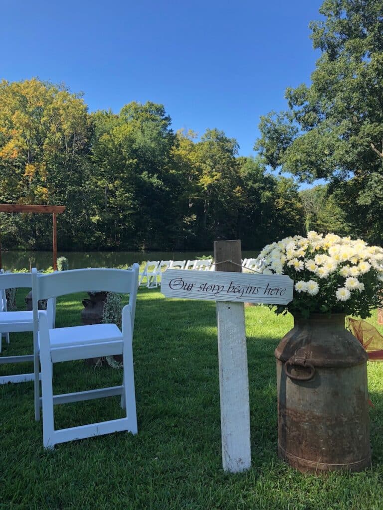 Sogn thay reads "Our story begins here" at an Adelyn Farm Wedding